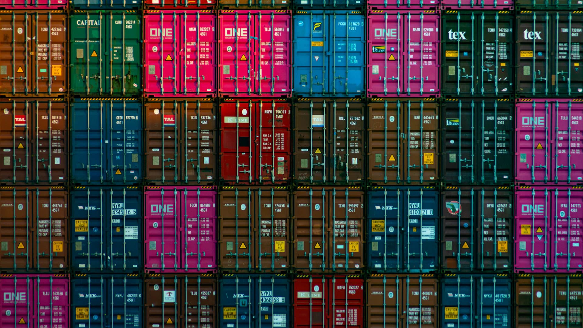 Shipping containers moving through an international trade hub