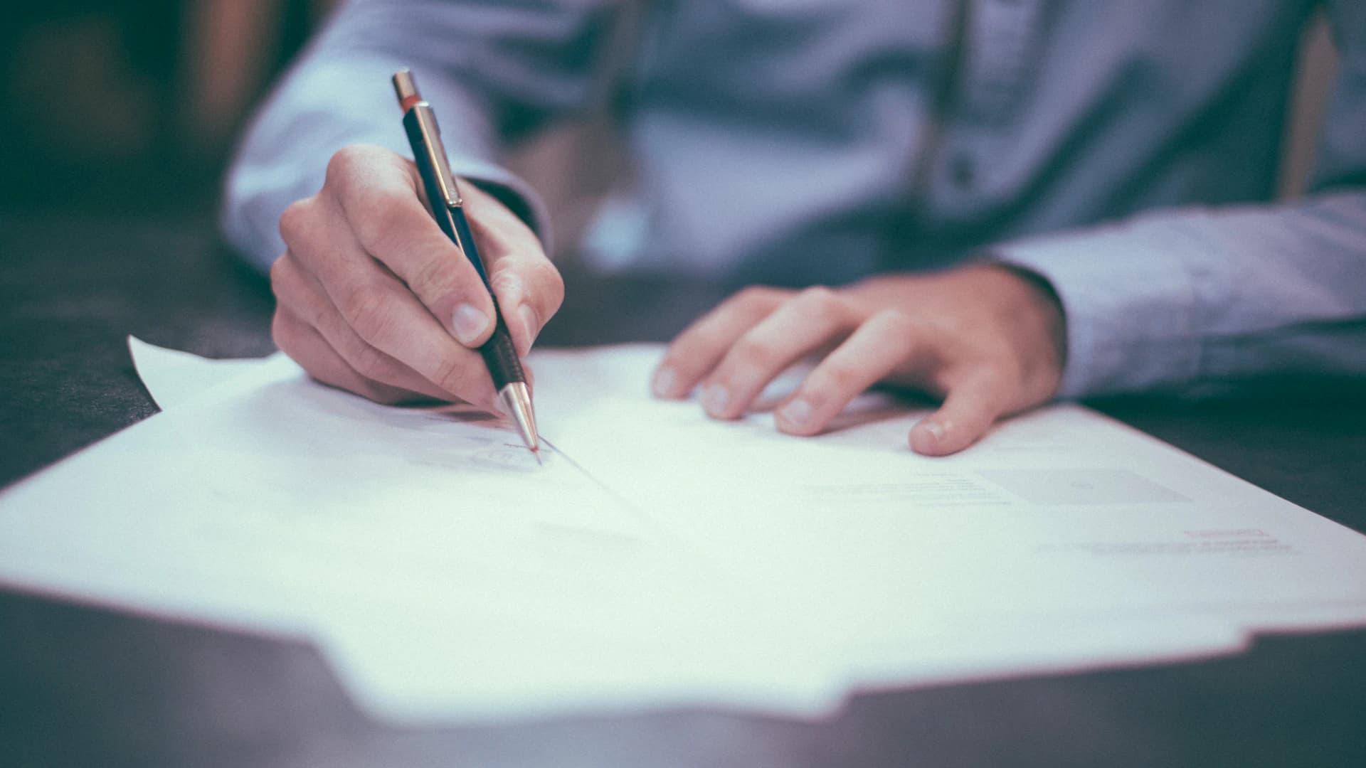 A professional reviewing and signing formal terms