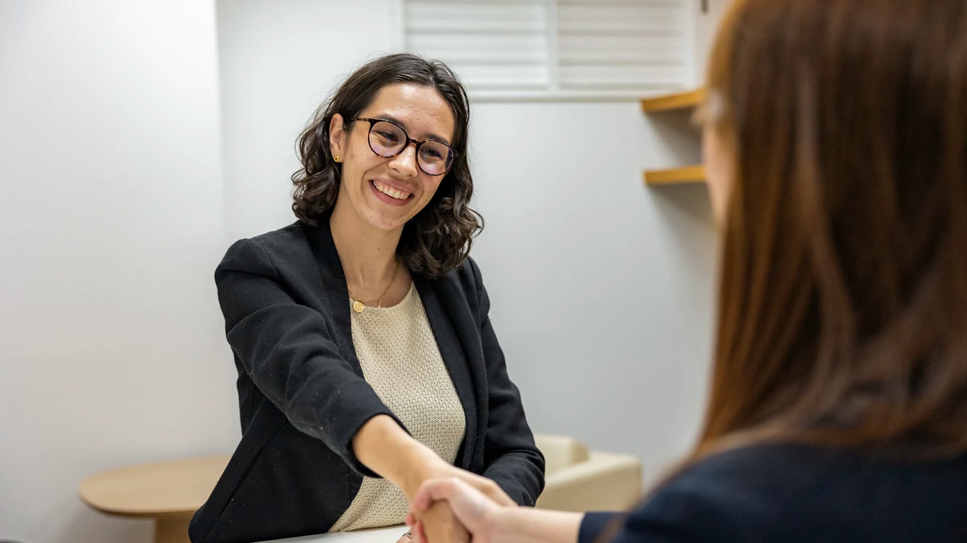 A candidate being welcomed during a professional interview