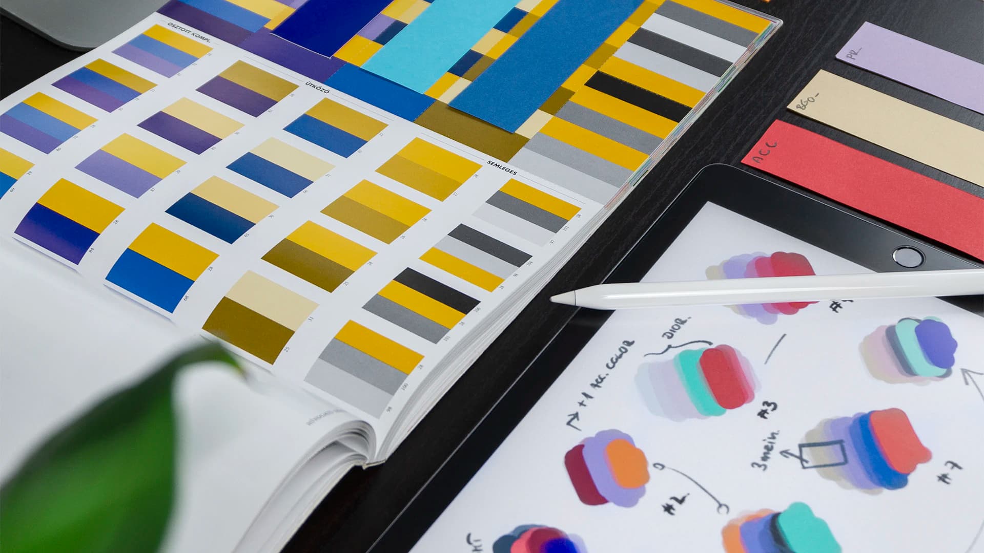 Advertising concepts and brand colour studies arranged on a creative desk