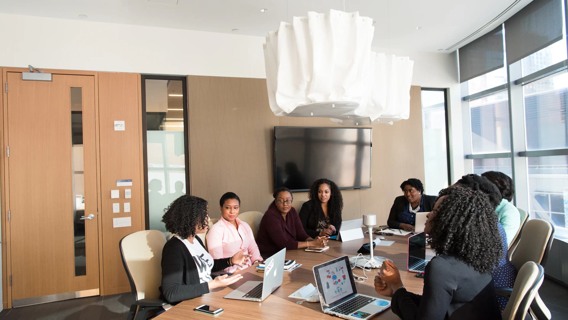 A diverse professional team sharing perspectives around a meeting table