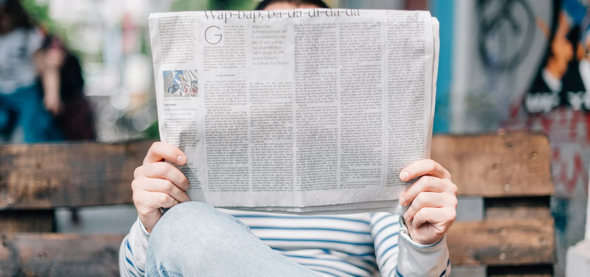 A reader engaging with the latest newspaper coverage